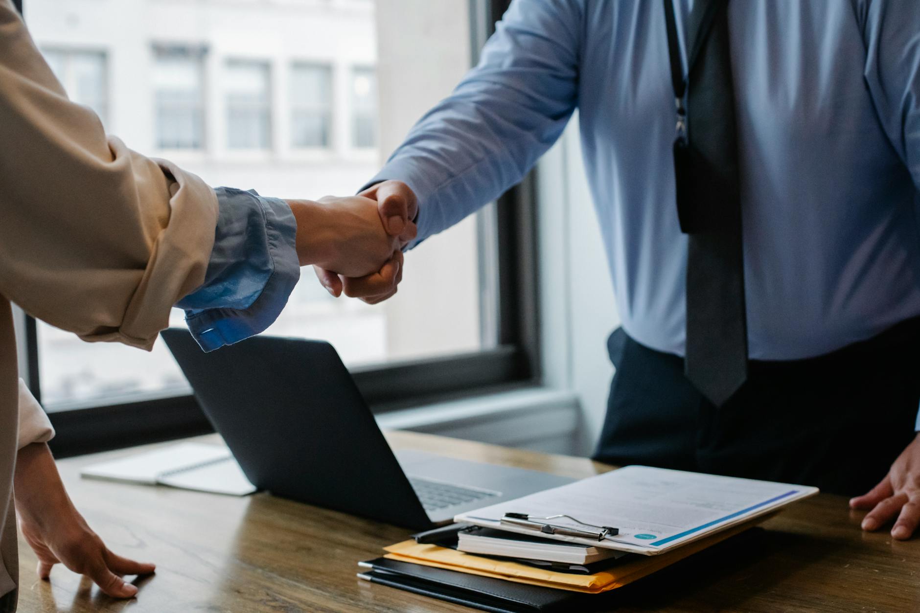 shaking hands in office after job interview
